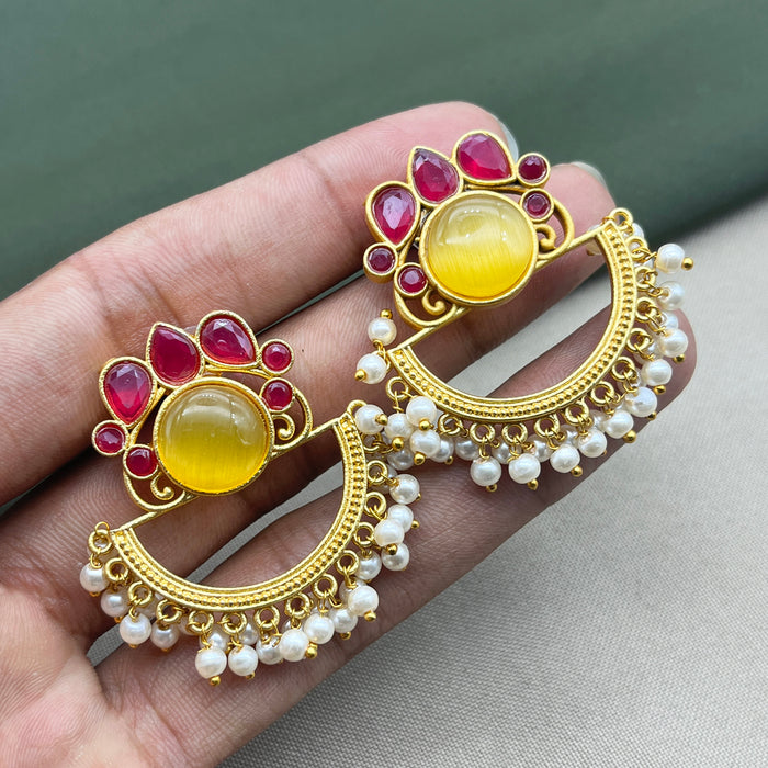 Diwam Jewels' gold-plated Traditional and Meenakari Earring Set featuring vibrant pink and yellow stones, paired with beautiful pearls