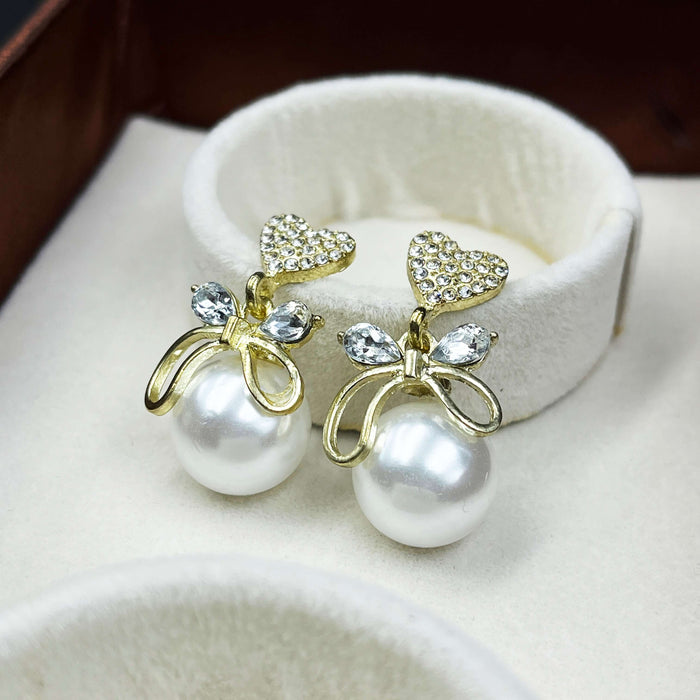 Gold-Plated Heart & Bow Pearl Drop Earrings with CZ Stones